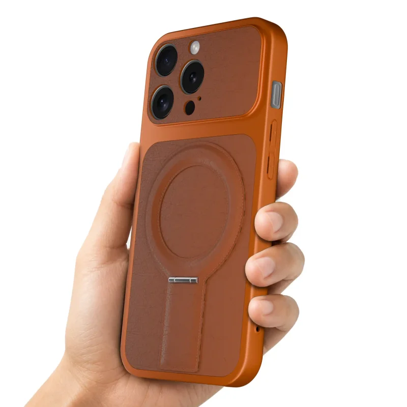 Pomarańczowe etui magnetyczne do iPhone 14 Pro prezentowane w dłoni