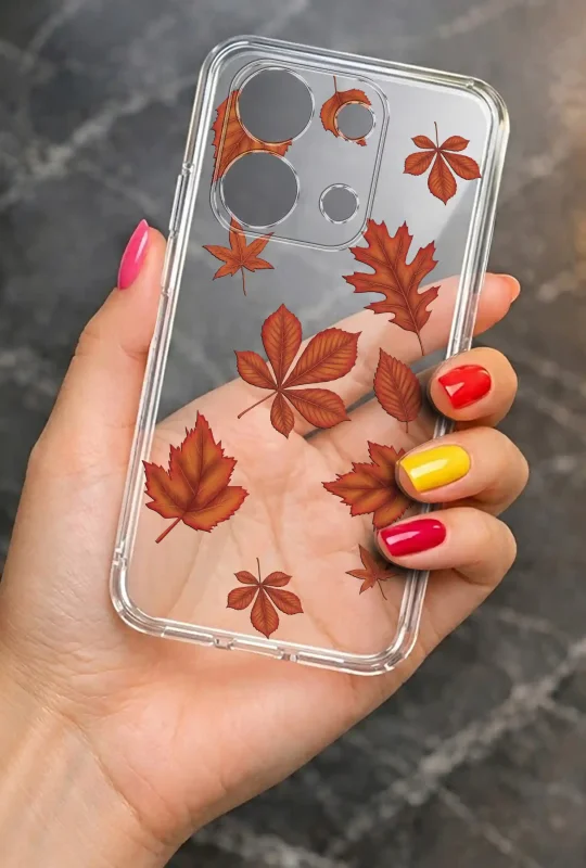 Przezroczyste etui do Xiaomi Redmi Note 13 Pro 4G z motywem jesiennych liści prezentowane w dłoni